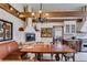 Bright eat-in dining space with brick fireplace, beams, and modern appliances, ideal for casual meals and gatherings at 385 Grimes Bridge Rd, Roswell, GA 30075