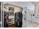 Walk-in closet with mirrored sliding door leading to a dressing room with vanity and lots of natural light at 385 Grimes Bridge Rd, Roswell, GA 30075