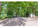 Gated entrance to a secluded property with lush landscaping and ample privacy, creating a serene and welcoming approach at 385 Grimes Bridge Rd, Roswell, GA 30075