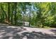 Secluded home with long drive in a lush forest with ample parking, providing a private and serene setting at 385 Grimes Bridge Rd, Roswell, GA 30075