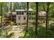 Exterior showcasing multiple decks and wooded surroundings, creating a tranquil setting at 385 Grimes Bridge Rd, Roswell, GA 30075