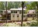 Rear exterior showcasing multiple decks and a secluded, wooded backdrop, offering privacy at 385 Grimes Bridge Rd, Roswell, GA 30075