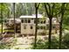 Exterior view of the home featuring multiple decks and lush trees at 385 Grimes Bridge Rd, Roswell, GA 30075