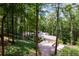 Secluded home nestled in a lush, green forest with long drive and ample parking at 385 Grimes Bridge Rd, Roswell, GA 30075
