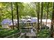 Stunning home exterior nestled in a wooded area with a walkway leading to the entrance at 385 Grimes Bridge Rd, Roswell, GA 30075