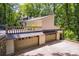 Exterior featuring a large driveway leading to a three-car garage and a deck with ornate railings at 385 Grimes Bridge Rd, Roswell, GA 30075