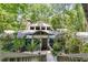 Beautiful home exterior with stone accents, mature trees, and unique architectural details at 385 Grimes Bridge Rd, Roswell, GA 30075