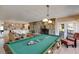 Open concept game room with a billiards table and a stone fireplace, perfect for entertaining at 385 Grimes Bridge Rd, Roswell, GA 30075