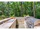Built-in stone outdoor grill with counterspace, stainless steel appliances, and wooded view at 385 Grimes Bridge Rd, Roswell, GA 30075