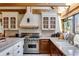This kitchen has wooden beams, stainless appliances, and a farmhouse sink at 385 Grimes Bridge Rd, Roswell, GA 30075