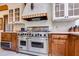 This kitchen features a large Viking range, custom hood, and warm wood cabinetry at 385 Grimes Bridge Rd, Roswell, GA 30075