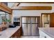 Spacious kitchen featuring stainless steel refrigerator, wood cabinets and tile backsplash at 385 Grimes Bridge Rd, Roswell, GA 30075