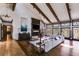 Spacious living room with fireplace, wood beams, large windows, and hardwood floors at 385 Grimes Bridge Rd, Roswell, GA 30075