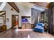 Bright living room with an aquarium, wooden beams, large windows, and comfortable seating at 385 Grimes Bridge Rd, Roswell, GA 30075