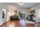 Spacious living room featuring gleaming hardwood floors and a door to the patio at 385 Grimes Bridge Rd, Roswell, GA 30075