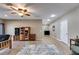 Spacious living room with hardwood floors, ceiling fan, recessed lighting, and classic wood furniture at 385 Grimes Bridge Rd, Roswell, GA 30075