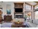Cozy living room with decorative fireplace, large windows, and hardwood floors, perfect for relaxation and entertaining at 385 Grimes Bridge Rd, Roswell, GA 30075
