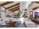 Bright living room features vaulted ceilings, wood beams, and seamless transition to dining room, offering a modern design at 385 Grimes Bridge Rd, Roswell, GA 30075