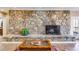 Comfortable living room featuring a stone fireplace, a decorative table, and hardwood floors at 385 Grimes Bridge Rd, Roswell, GA 30075