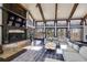 Bright living room with high ceilings, wood beams, large windows, fireplace, and a comfortable sectional sofa at 385 Grimes Bridge Rd, Roswell, GA 30075