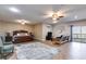 Spacious primary bedroom with a wooden bed frame, seating area, and a sliding glass door to a patio at 385 Grimes Bridge Rd, Roswell, GA 30075