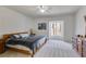 Main bedroom featuring natural light, neutral carpet, and classic wooden furniture at 385 Grimes Bridge Rd, Roswell, GA 30075