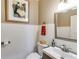 Classic powder room features wainscoting, framed art, and a modern sink with chrome fixtures at 385 Grimes Bridge Rd, Roswell, GA 30075