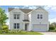 Charming two-story home featuring a brick facade, covered entry, and an attached two-car garage at 4188 Brindle Pl, Loganville, GA 30052