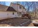 Charming backyard with a cozy deck, stone pathway, and wooded surroundings offers tranquility and privacy at 5050 Brownwood Dr, Powder Springs, GA 30127