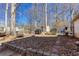 Outdoor space features a fire pit, BBQ, and a shed in a wooded area with a chain-link fence at 5050 Brownwood Dr, Powder Springs, GA 30127