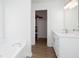 Bright Primary bathroom boasts double vanity, bathtub, and walk-in closet at 5050 Brownwood Dr, Powder Springs, GA 30127