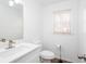 Clean half-bath featuring a white vanity, modern faucet, and a window for natural light at 5050 Brownwood Dr, Powder Springs, GA 30127