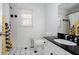 Well-lit bathroom features stylish vanity, tiled floor, and bathtub, creating a relaxing and functional space at 5050 Brownwood Dr, Powder Springs, GA 30127
