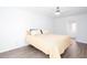 Cozy bedroom with light wood grain floors, neutral walls, and a view to the ensuite at 5050 Brownwood Dr, Powder Springs, GA 30127