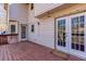 Outdoor wooden deck with a serene view of the backyard and access to house through glass paned doors at 5050 Brownwood Dr, Powder Springs, GA 30127