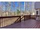 Inviting wooden deck offers a relaxing outdoor space overlooking the serene, wooded backyard at 5050 Brownwood Dr, Powder Springs, GA 30127