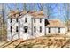 Charming two-story home featuring a stucco facade, black front door, and a well-maintained lawn at 5050 Brownwood Dr, Powder Springs, GA 30127