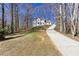 A two-story home sits atop a hill, accessed by a long, private driveway at 5050 Brownwood Dr, Powder Springs, GA 30127
