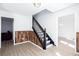 Open floorplan of the entry way features decorative wood trim and a staircase with black railings at 5050 Brownwood Dr, Powder Springs, GA 30127