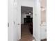 Hallway view into a living room with a brick fireplace and an adjacent half-bathroom at 5050 Brownwood Dr, Powder Springs, GA 30127