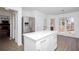 Eat-in kitchen features stainless appliances, white cabinets, and natural light pouring from the large windows at 5050 Brownwood Dr, Powder Springs, GA 30127