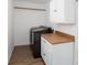 Convenient laundry room with modern appliances, storage cabinets, and ample space for sorting and folding at 5050 Brownwood Dr, Powder Springs, GA 30127