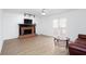 Comfortable living room with wood-look floors, brick fireplace, and a ceiling fan at 5050 Brownwood Dr, Powder Springs, GA 30127