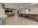 Large basement includes media area, game table, wood beams, recessed lighting and white walls at 114 Rock Creek Ln, Canton, GA 30114