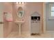 Bathroom featuring an oval mirror, a pedestal sink, and a decorative cabinet with neatly rolled towels at 114 Rock Creek Ln, Canton, GA 30114