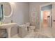 Bathroom with a toilet, sink, patterned rug, and a doorway to another bathroom with pink walls and accessories at 114 Rock Creek Ln, Canton, GA 30114
