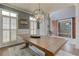 Open-concept dining room showcasing a wooden table, shuttered windows, and decorative lighting at 114 Rock Creek Ln, Canton, GA 30114