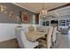 Dining room has elegant chandelier, dark accent wall with wainscoting, and stylish furnishings at 114 Rock Creek Ln, Canton, GA 30114