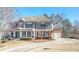 Charming two-story home featuring a inviting front porch and attached two car garage at 114 Rock Creek Ln, Canton, GA 30114