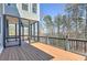 Large deck leading to screened-in porch with wooded area views at 114 Rock Creek Ln, Canton, GA 30114